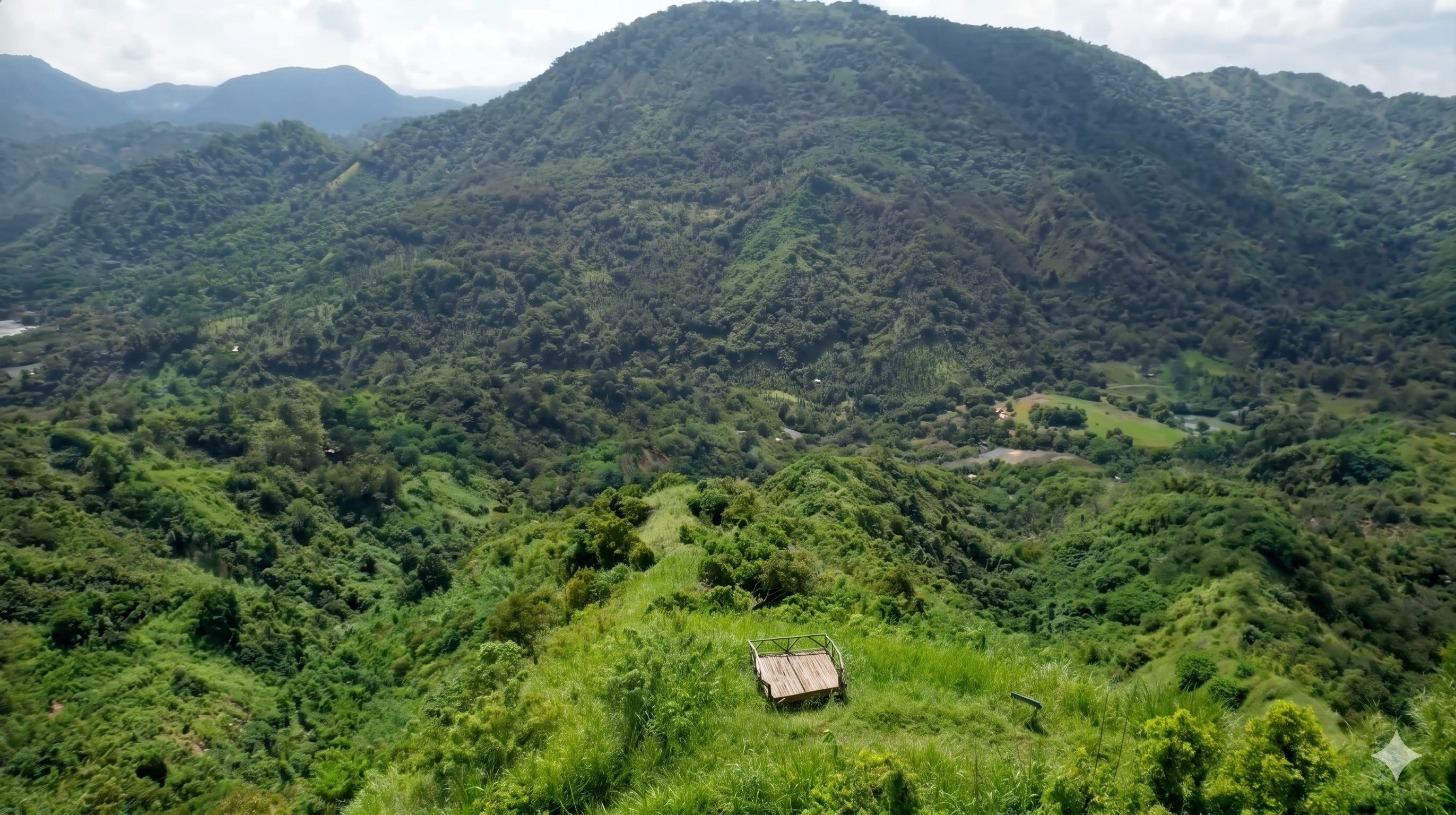 View deck on Mt. Lubo Peak 2 overlooking green ridges and the property below